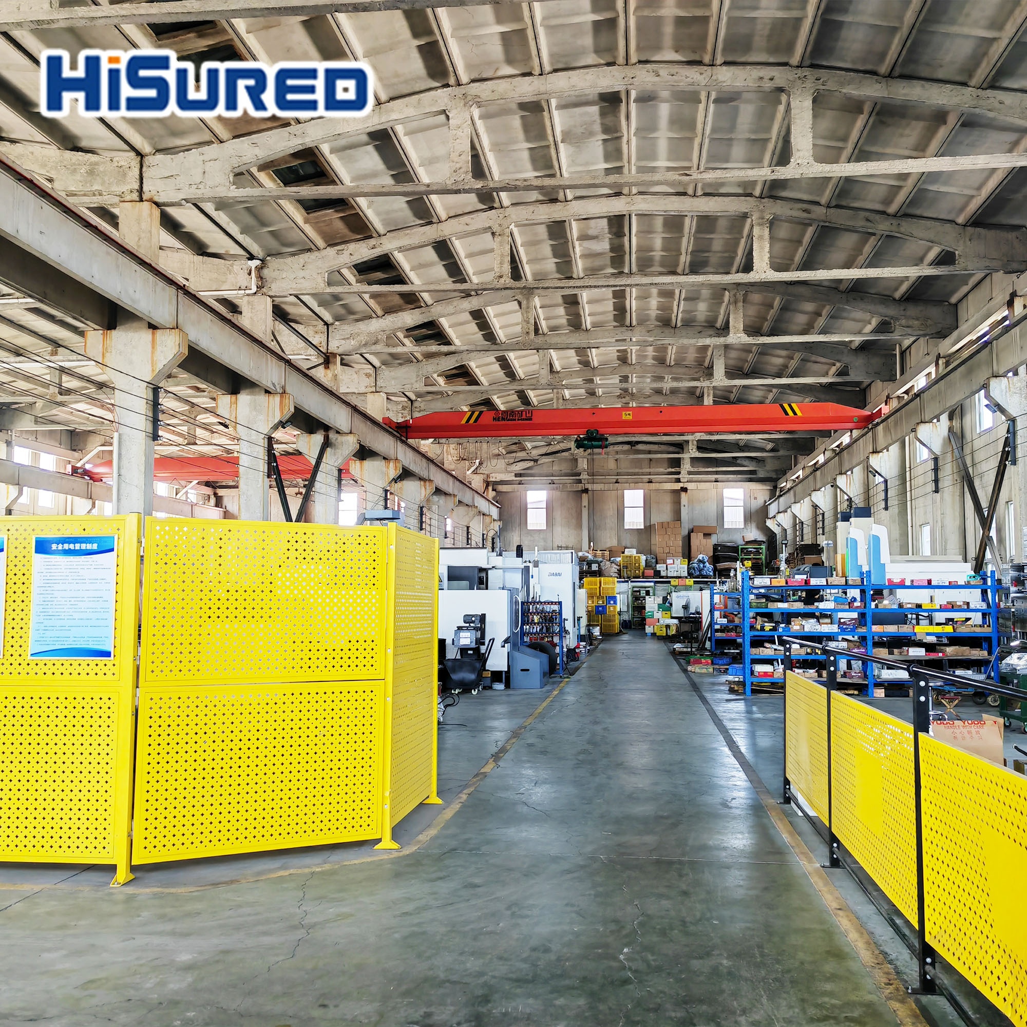 Interior view of the Hisured Mold factory floor with CNC machines, material shelving and an overhead crane