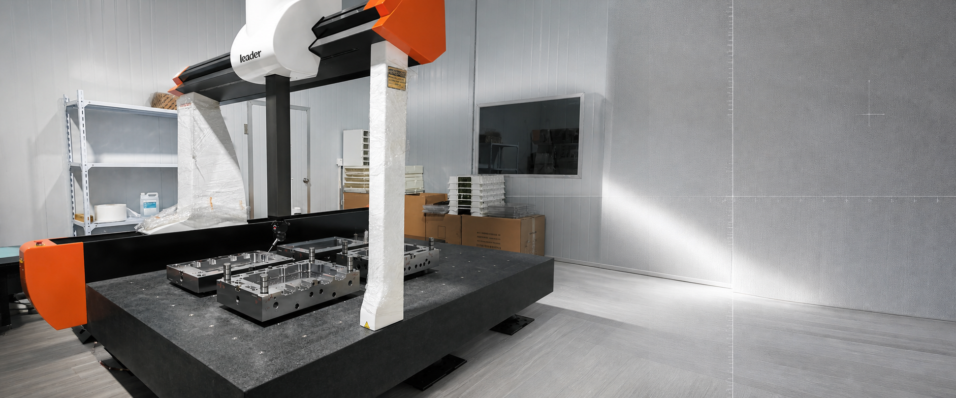 CMM coordinate measuring machine inspecting mold base components on a granite table
